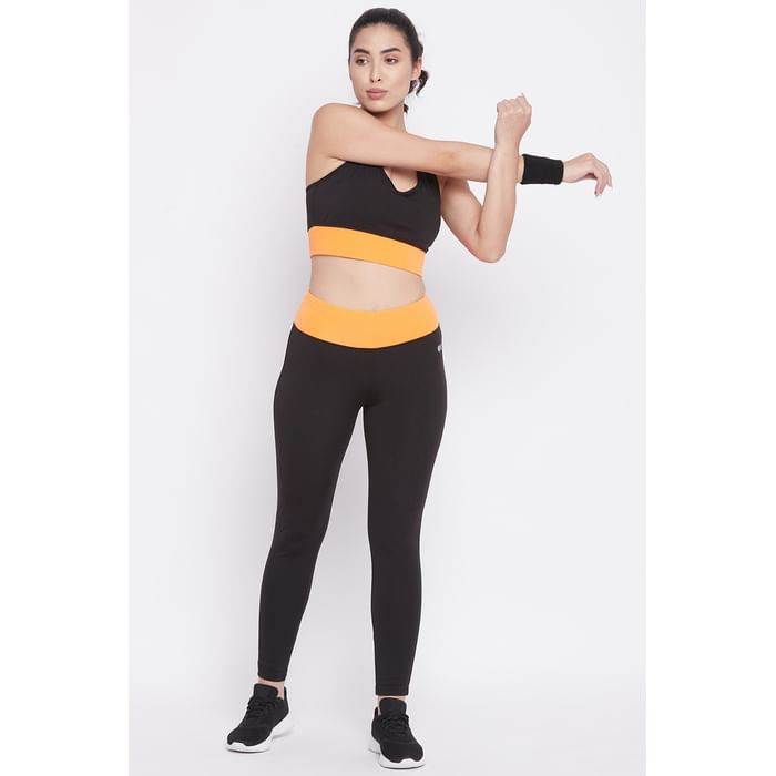 

Clovia Medium Impact Padded Racerback Sports Bra & Snug Fit Active Tights in Black - ASC020P16, Orange